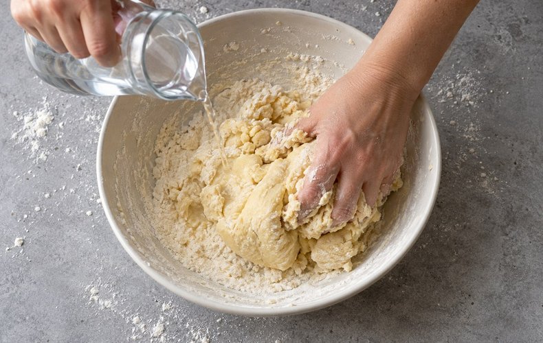 Acciuleddi (Sardinian Honey Twists), step 1: kneading the dough with flour, lard, sugar and egg