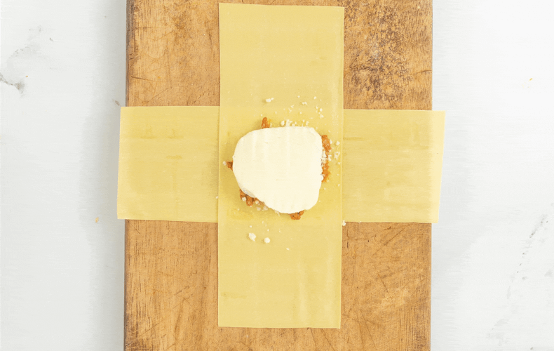 Folding the pasta strips to close a lasagna bundle
