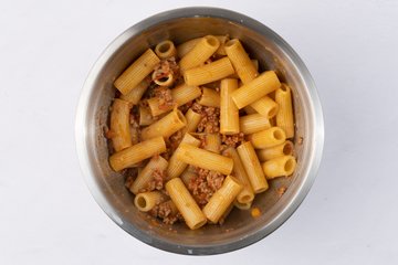 Pasta mixed with meat ragù and grated cheese