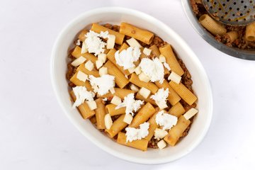 Cubes of scamorza and mozzarella scattered over the pasta