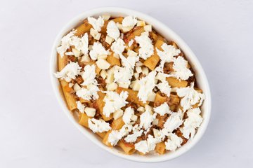 Last layer of pasta topped with mozzarella and grated cheese