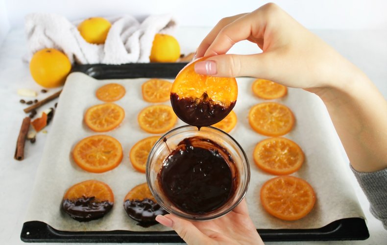 Candied orange slice dipped in melted dark chocolate