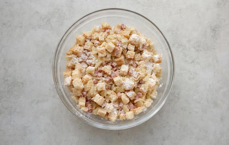 Canederli in Tomato Sauce, step 3: diced bread, speck and flour in a bowl