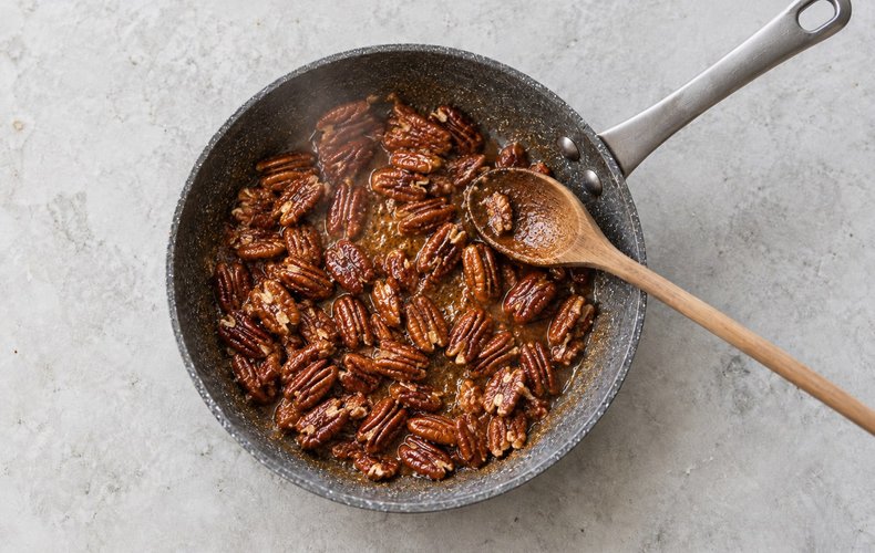 Caramelized Pecans, step 2: the pecans stirred as the sugar turns into amber caramel