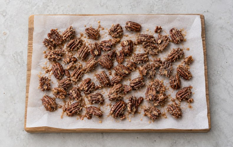 Caramelized Pecans, step 3: the caramelized pecans cooling on parchment paper