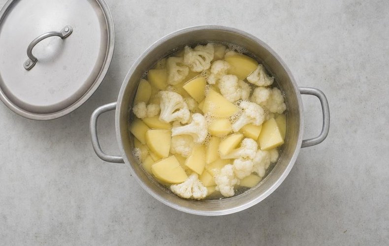 Cauliflower Puree, step 2: potatoes and cauliflower cooking in a saucepan of water