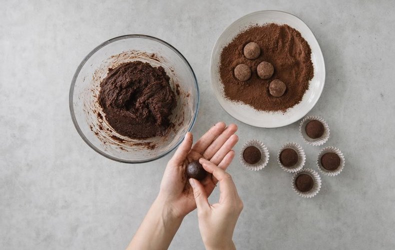 Chestnut Truffles, step 6: truffles rolled in cocoa and set in paper cups