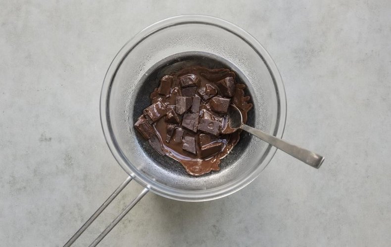 Chocolate Caramel Apples, step 1: dark chocolate melting in a double boiler