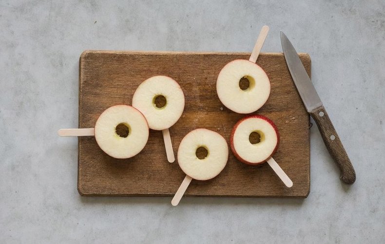 Chocolate Caramel Apples, step 2: apple slices on ice-pop sticks