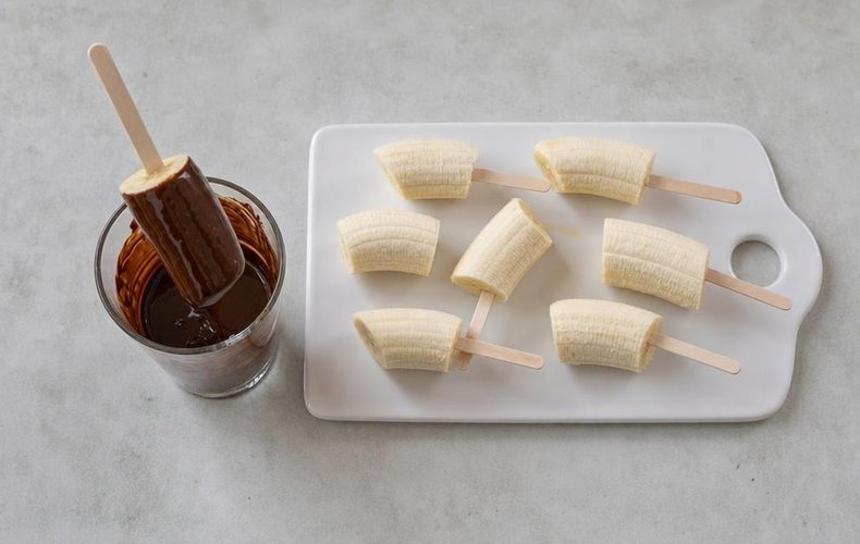 Chocolate-Covered Bananas, step 3: a banana half dipped in melted dark chocolate
