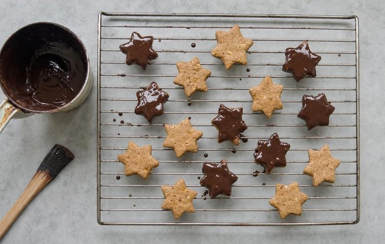 Chocolate-Covered Cookies, step 7: brushing the chocolate glaze over the cookies