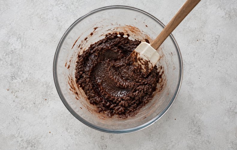 Chocolate Crinkle Cookies, step 1: cocoa, sugar and vegetable oil mixed in a bowl