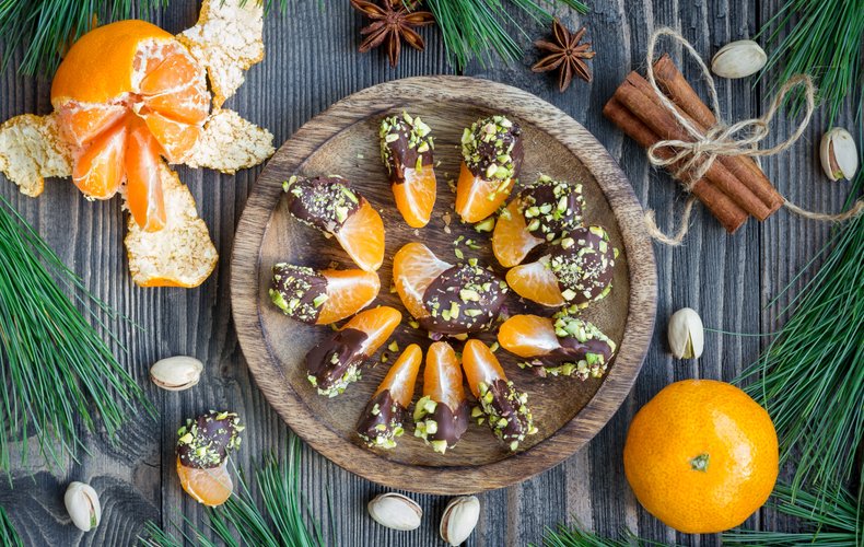 Mandarin segments dipped in dark chocolate and pistachios