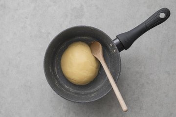 Chocolate Profiteroles, step 2: the dough stirred with a wooden spoon