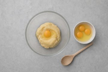 Chocolate Profiteroles, step 2: adding the eggs to the dough one at a time