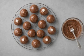 Chocolate Profiteroles, step 9: cream puffs dipped in the chocolate ganache