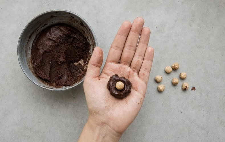 Chocolate Truffles with a Hazelnut Center, step 4: a hazelnut placed in the center of the chocolate mixture
