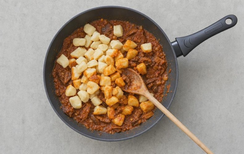 Christmas Eve Gnocchi, step 8: the gnocchi tossed in the skillet with the sauce