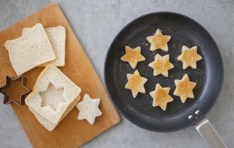 Christmas Star Mini Sandwiches, step 1: stars cut from sandwich bread and toasted in a skillet