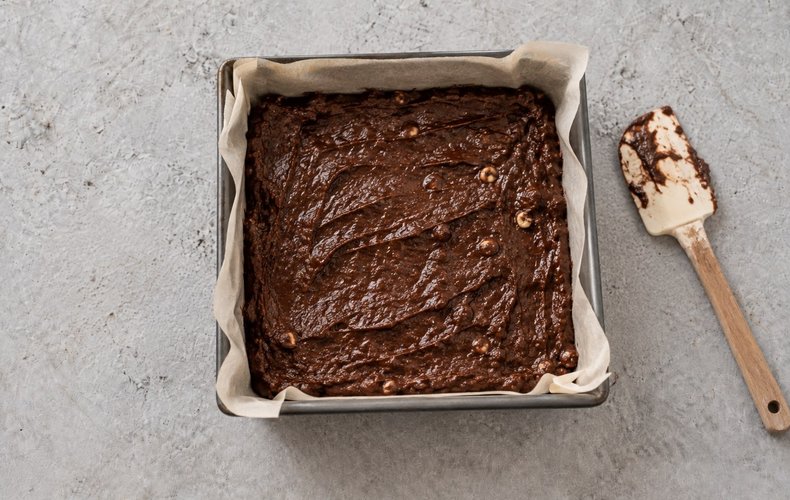 Christmas Tree Brownies, step 6: the brownie in a square pan lined with parchment paper