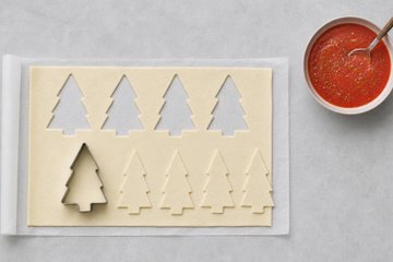 Christmas Tree Mini Pizzas, step 2: cutting trees out of the puff pastry