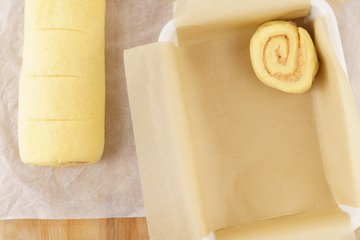 Cinnamon rolls arranged in a lined baking pan