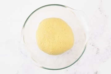Cinnamon roll dough in a greased bowl
