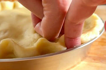 Crimping the edge of the apple pie