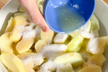 Sugar, brown sugar, and cinnamon added to the apples