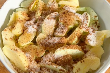 Spiced apples covered with plastic wrap to rest