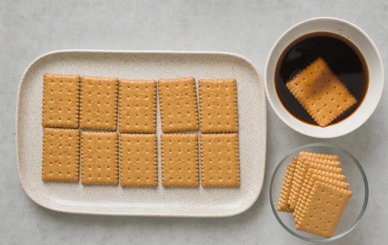 Coffee Mattonella (No-Bake Cookie Cake), step 4: cookies dipped in coffee arranged in a square
