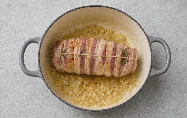 Veal Roast with Cream, step 3: the pancetta-wrapped roast browning in the pan