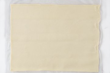 Unrolling the sheet of pastry