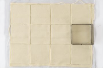 Cutting squares from the pastry with a square cutter