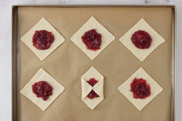 Brushing the pastry with egg white