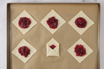 Folding the corners of the pastry into envelopes