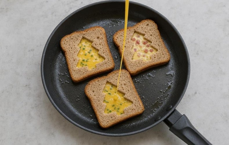 Frittata-in-a-Hole Toasts, step 5: bread slices in a pan filled with beaten egg