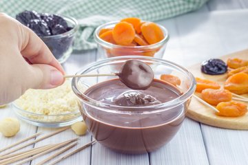 Fruit skewers dipped in melted dark chocolate