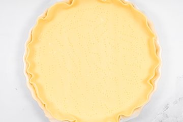 Pricking the pastry base with a fork