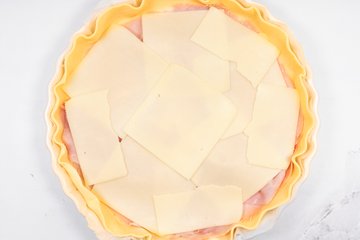 Adding a layer of sliced Emmental