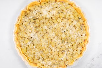 Sprinkling with grated Grana Padano before baking