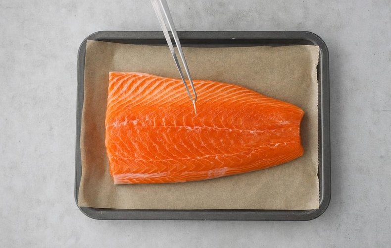 Salmon fillet on a baking sheet lined with parchment paper