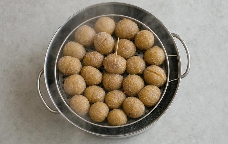 Homemade Marrons Glacés, step 4: peeled chestnuts in a steamer basket
