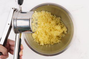 Homemade Mashed Potatoes, step 2: passing the potatoes through a potato ricer
