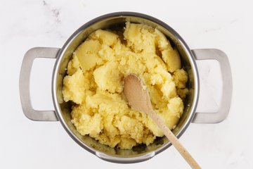 Homemade Mashed Potatoes, step 3: riced potatoes transferred to a pot