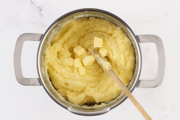 Homemade Mashed Potatoes, step 4: whisking the milk into the potatoes