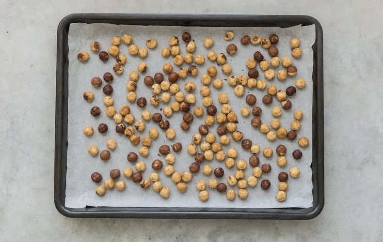 Homemade Soft Torrone, step 1: hazelnuts spread on a baking sheet for toasting