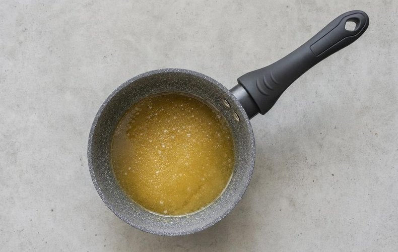 Homemade Soft Torrone, step 2: sugar and honey melting in a heavy-bottomed pot