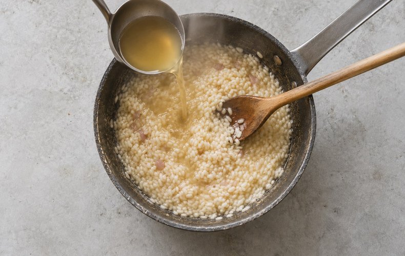 Honey, Sage and Rosemary Risotto, step 3: adding hot broth to the rice