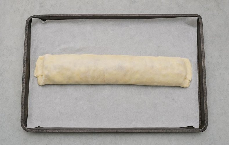 Iginio Massari's Apple Strudel, step 9: the strudel on a baking sheet lined with parchment paper